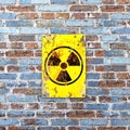 Nuclear site, sign hanging on a brick wall. Indication of the presence of a radioactive area