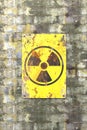 Nuclear site, sign hanging on a brick wall. Indication of the presence of a radioactive area