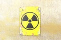 Nuclear site, sign hanging on a yellow wall. Indication of the presence of a radioactive area