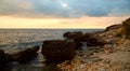 Nude beach. Virgin nature. Summer time view. Sunset. Beautiful mountains. Calming crystal clean water. Rocky coastline