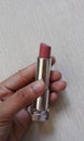 Nude lipstick in a hand Royalty Free Stock Photo