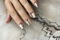 Nude manicure with graphic patterns and rhinestones