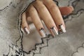 Nude manicure with graphic patterns and rhinestones.