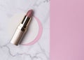 Nude pink lipstick on creative marble and pastel pink background with copy space