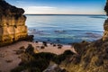 A nude woman is standing on the yellow rock with raised arms and meeting the sun on the Royalty Free Stock Photo