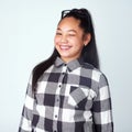 Nudge nudge, wink wink. Studio portrait of a cute and confident young girl posing against a gray background. Royalty Free Stock Photo