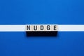 Nudge word concept on cubes