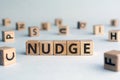 Nudge - word from wooden blocks with letters Royalty Free Stock Photo