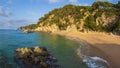 Nudist beach in Spain, Cala sa Boadella, Costa Brava, Lloret de Mar. Sandy spanish beach with rocks and stones in water