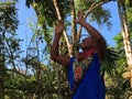 Elderly indigenous shaman of Cofan nationality performing a healing ritual with his arms raised in the Amazon rainforest