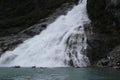 Nugget Falls splashing into Mendenhall Lake Royalty Free Stock Photo