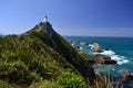 Nugget point, romantic landscape with white lighthouse, unique rocks in the sea