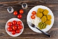 Nuggets with rice, tomatoes cherry in saucer, pepper, salt, fork Royalty Free Stock Photo