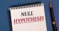NULL HUPOTHESIS - words in a white notebook on a blue background with a pen