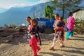Nepalese women in colorful clothes carrying child while walking outside i
