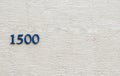 The number 1500 against a stucco wall