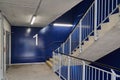 Number 1 on a blue-walled hallway and staircase