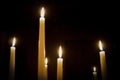 A number of burning melted candles with blurred forks of flame Royalty Free Stock Photo