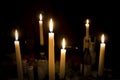 A number of burning melted candles with blurred forks of flame Royalty Free Stock Photo