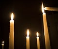 A number of burning melted candles with blurred forks of flame Royalty Free Stock Photo