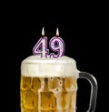 Number 49 candle in beer froth