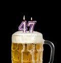 number 47 candle in beer mug