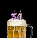 Number 34 candle in beer mug