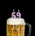 Number 59 candle in beer mug