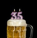 Number 35 candle in beer mug