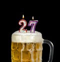 Number 27 candle in beer mug