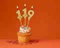 Birthday candle number 119 - Invitation card with orange background Royalty Free Stock Photo