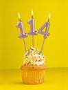 Birthday candle number 114 - Invitation card with yellow background Royalty Free Stock Photo