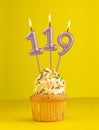 Number 119 candle - Birthday card design in yellow background Royalty Free Stock Photo