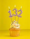Birthday candle number 132 - Invitation card with yellow background Royalty Free Stock Photo