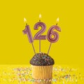 Number 126 candle - Birthday candle with chocolate cupcake Royalty Free Stock Photo