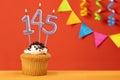 Number 145 candle - Birthday cupcake on orange background with bunting