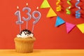 Number 139 candle - Birthday cupcake on orange background with bunting Royalty Free Stock Photo