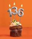 Number 136 candle - Birthday cupcake on orange background