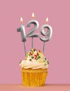 Number 129 candle with cupcake - Birthday card Royalty Free Stock Photo