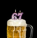Number 67 candle in beer