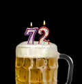 Number 72 candle in beer mug