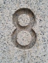 Number 8 carved in stone