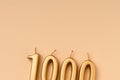 Number 1000 celebration festive background made with golden candles in the form of number Thousand