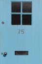 Number 75 close up on a blue door Royalty Free Stock Photo