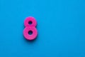 Number 8 color pink - Plastic piece on blue foamy background