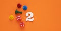 Number 2 with dice and board game pieces - Orange eva rubber background Royalty Free Stock Photo