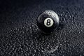 Number eight billiard ball with water drops on a black background Royalty Free Stock Photo