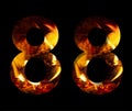 The number eight, 8 made from fire and burning wood on a black background, a double version of the alphabet for decorative Royalty Free Stock Photo