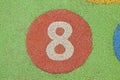 Number eight in a multicolored rubber outdoors children\'s playground