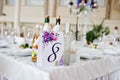 Number eight at table for guests on wedding hall. Royalty Free Stock Photo